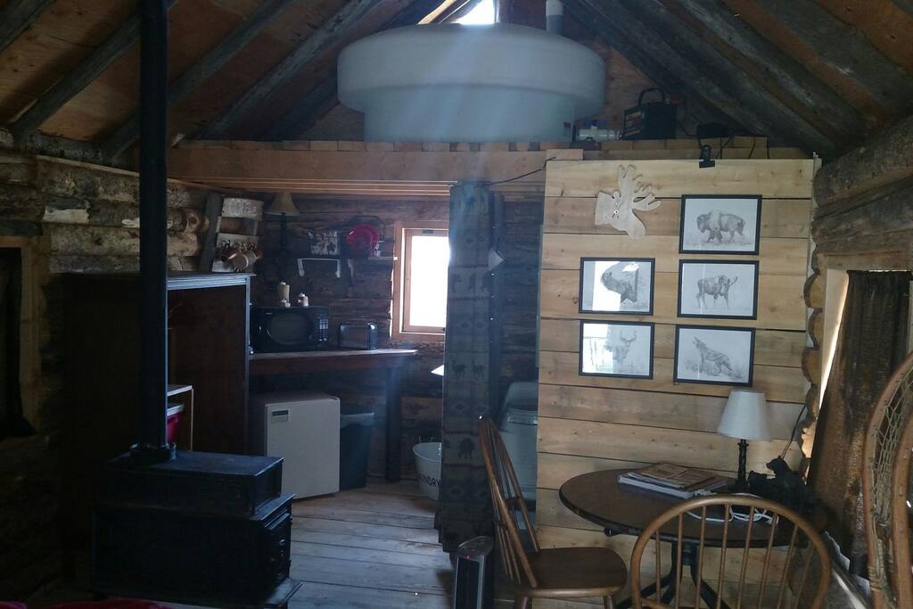 Off grid set up with holding tank in one of the lofts. Table with chairs and a kitchenette