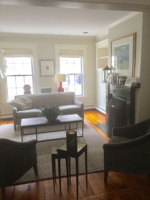 Lovely sitting room with original fireplace and lots of natural light