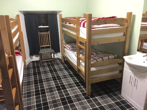 8-Bed family room at Chase The Wild Goose Hostel