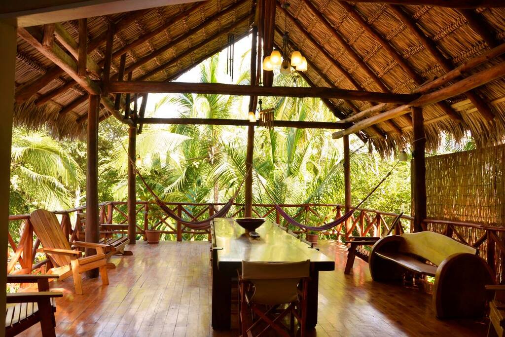 Pink Villa view from kitchen to palm hut