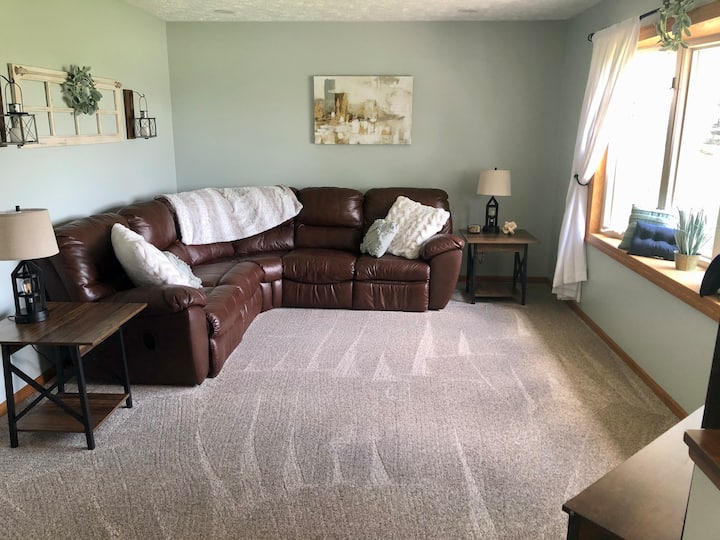 Living Room - Main Floor.  Has a sectional with recliners.  55'' Roku TV w/ Netflix.  Lamps w/ phone charger plug ins on each.  Very nice countryside view!