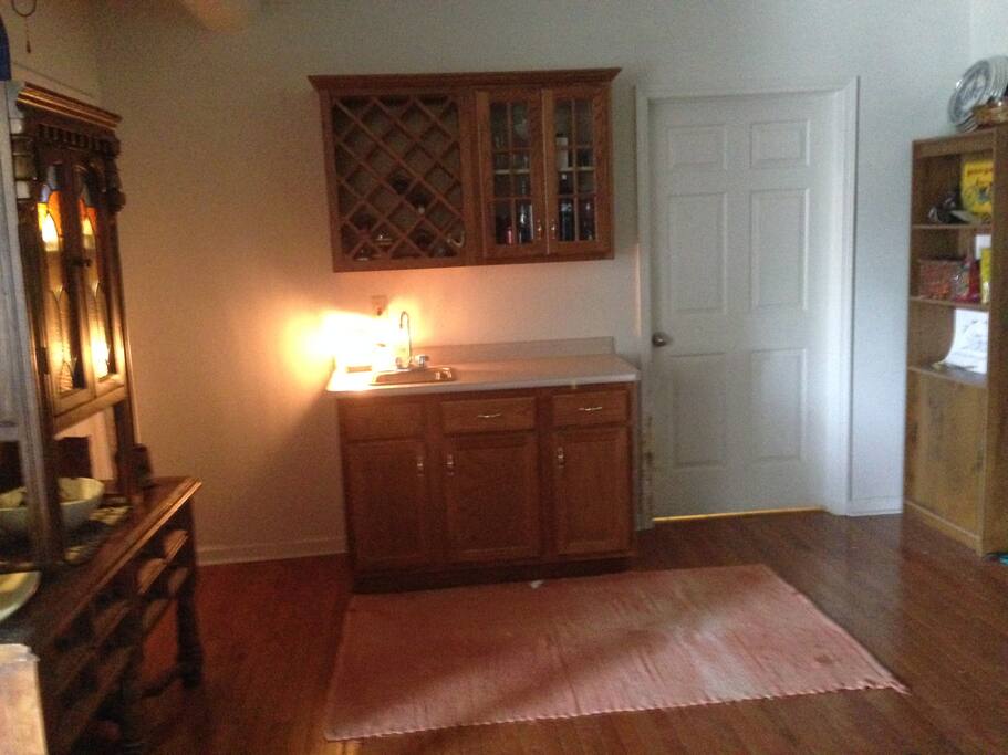 hutch on left with serving/party platters, wet bar with kitchen appliances available (crockpot, coffee pot, etc.)