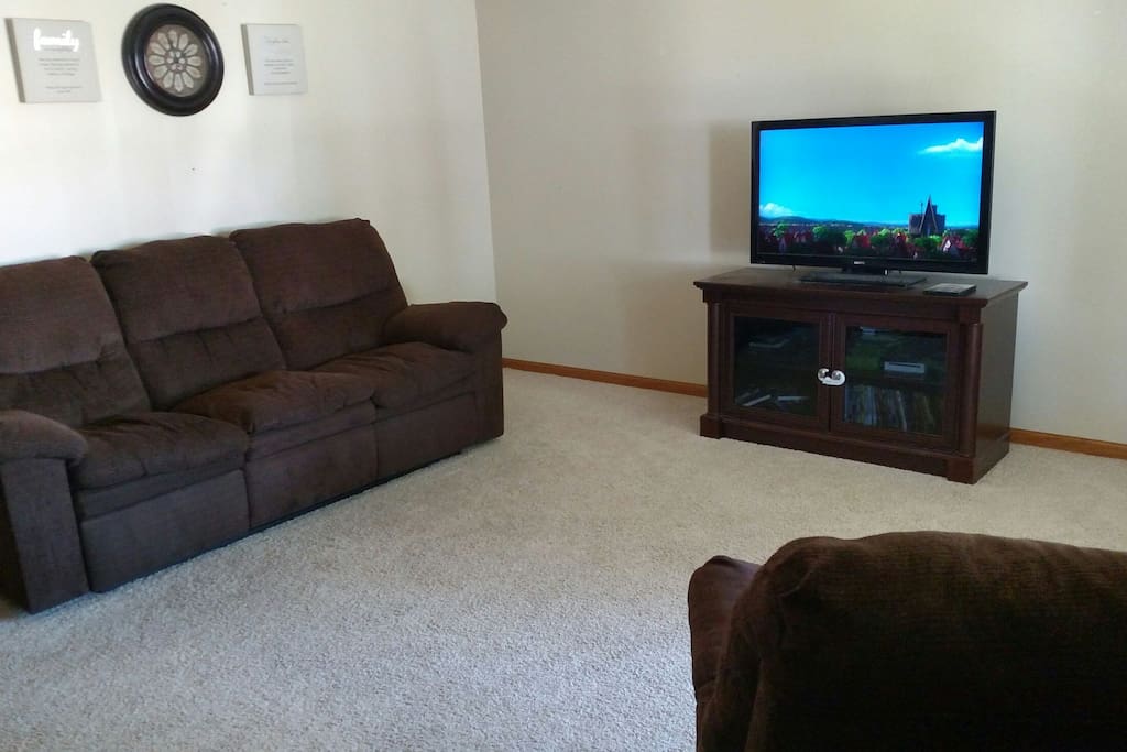 Couch, with recliners on both ends, recliner and DirecTV.