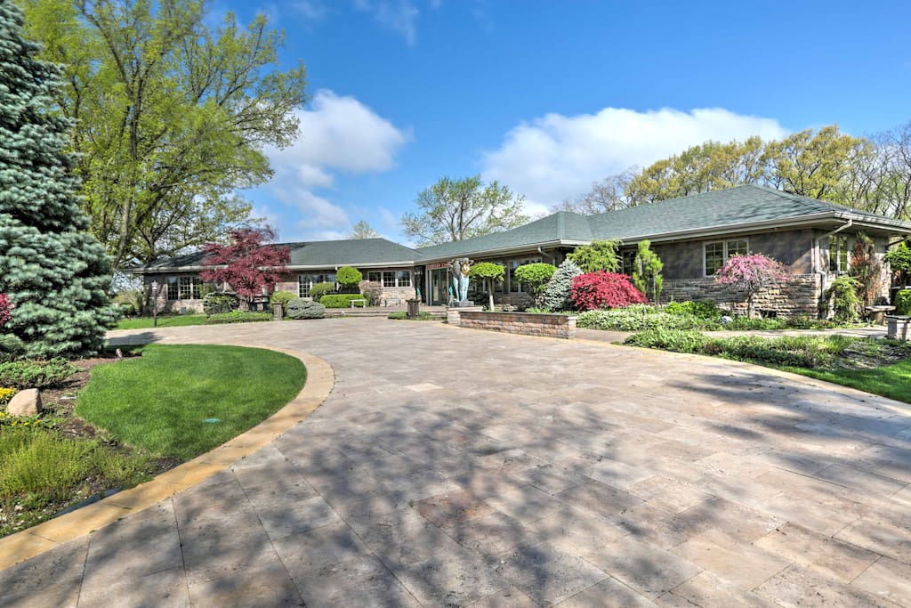 The home is situated on 5 well-groomed acres with a massive waterfall fountain.