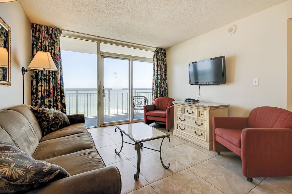 Overlooking the ocean, the living room offers direct access to the private balcony.