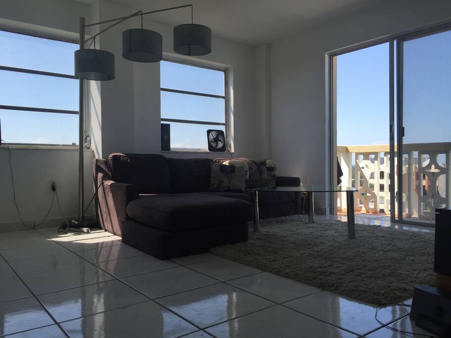 living room with north facing balcony with views of the ocean, indian creek, biscayne bay and downtown.
