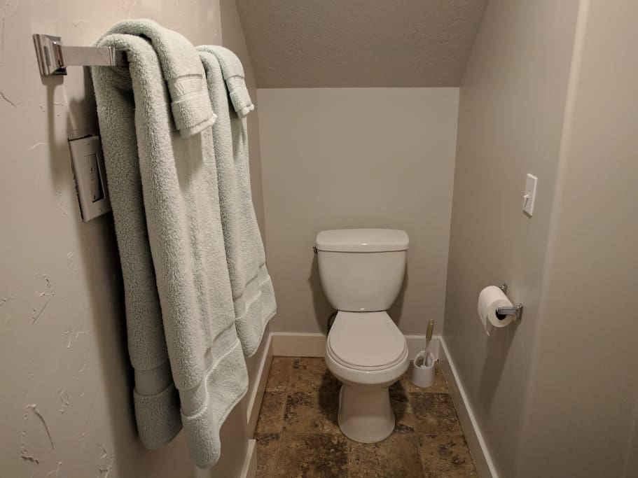 Private Bathroom With towels, wash cloths and toilet paper