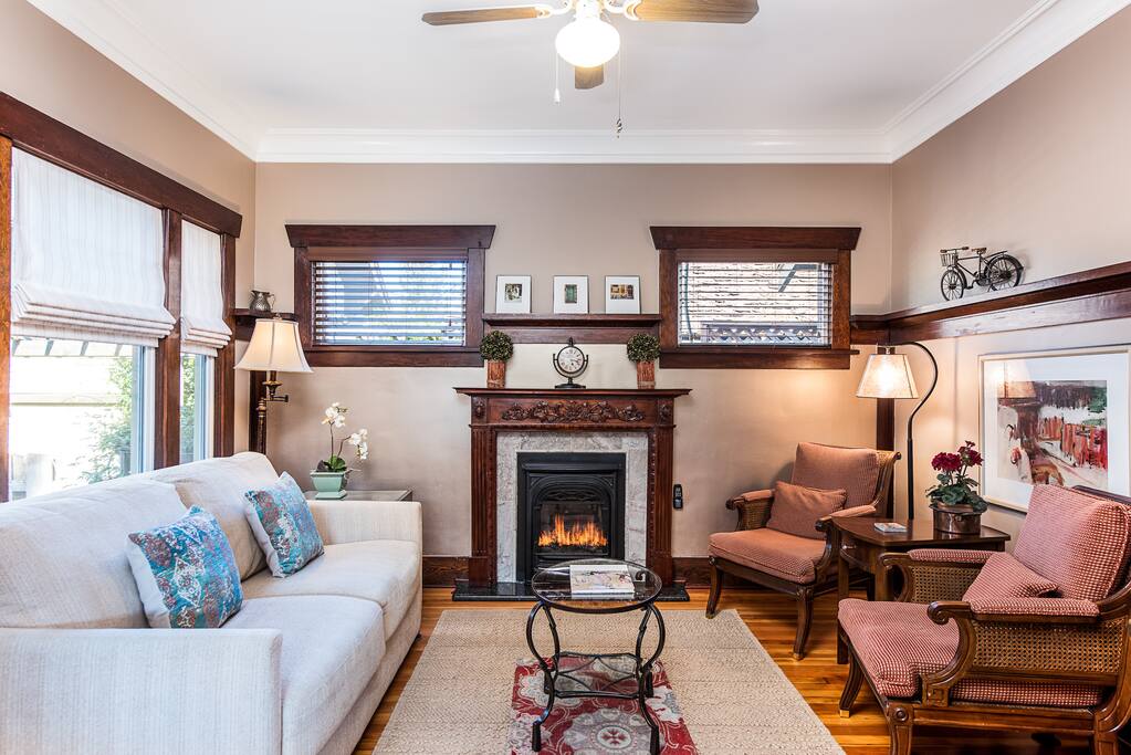 Intimate Living space with ample seating graced with a carved cherry mantel and fireplace as a center piece