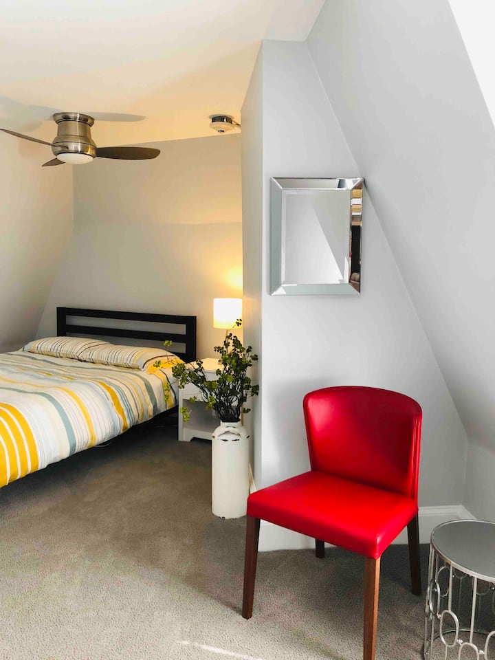 Bedroom with night stand, chest of drawers (6), ceiling fan and sitting area