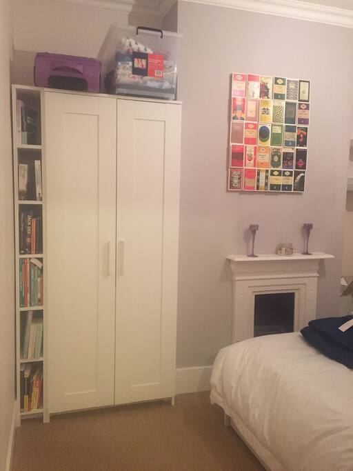 Guest bedroom with wardrobe and feature fireplace