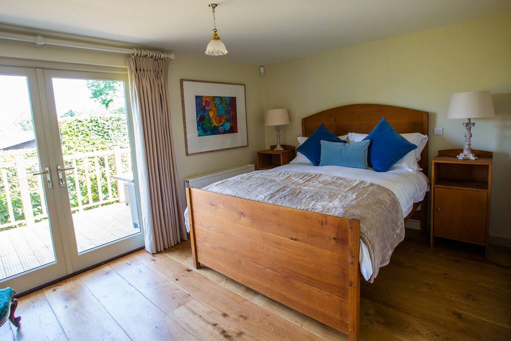 Kingsized solid oak bed with ensuite shower room and French doors onto decking