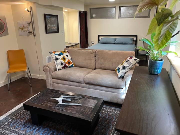 Queen bed with small closet, mirror and cupboard.