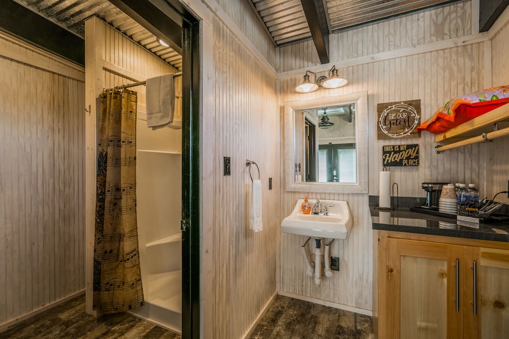 Full bathroom with shower and separate sink and closet area. (Fold-up Twin Cot in the corner near shower.)