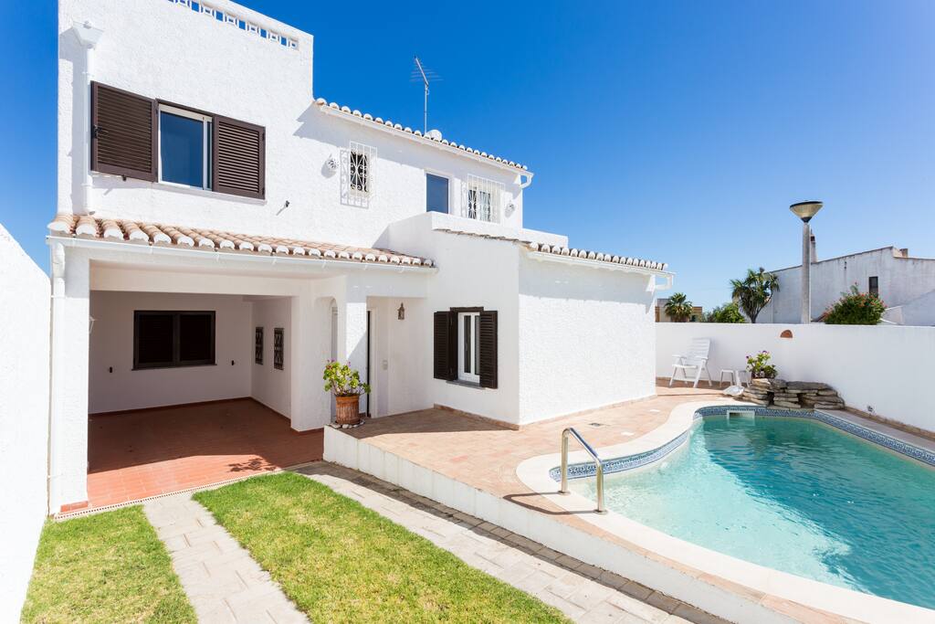 Front of house with pool carport and off-street parking