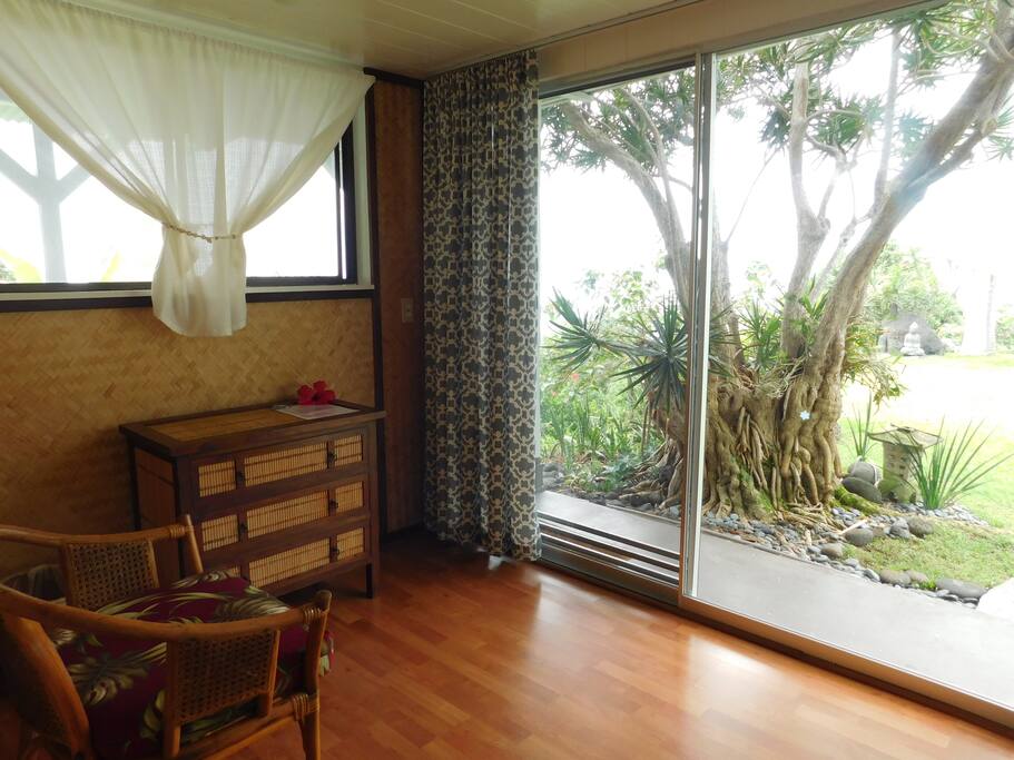 One of two large glass slider doors that open onto the lawn with panoramic views of the Honaunau coastline.
