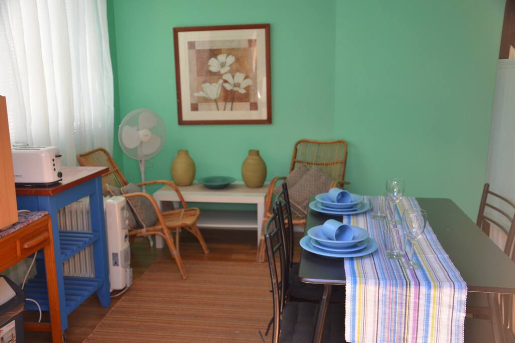 Living area of the studio with basic kitchenette includes a fridge.