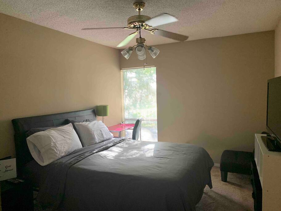 Your bedroom with natural light, complete with a desk, TV and AppleTV/Netflix