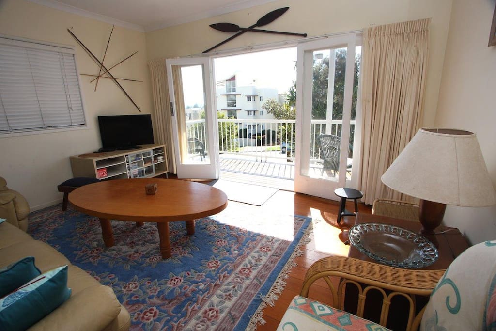 Upstairs lounge with a sunny north facing timber deck
