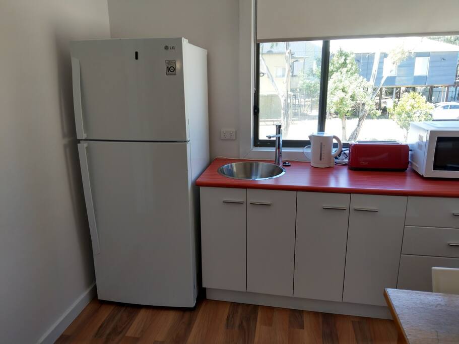 Kitchen with all cooking utensils, plates glasses etc