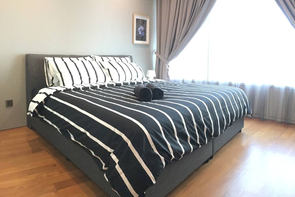 The master bedroom with a king sized bed & plush pillows.