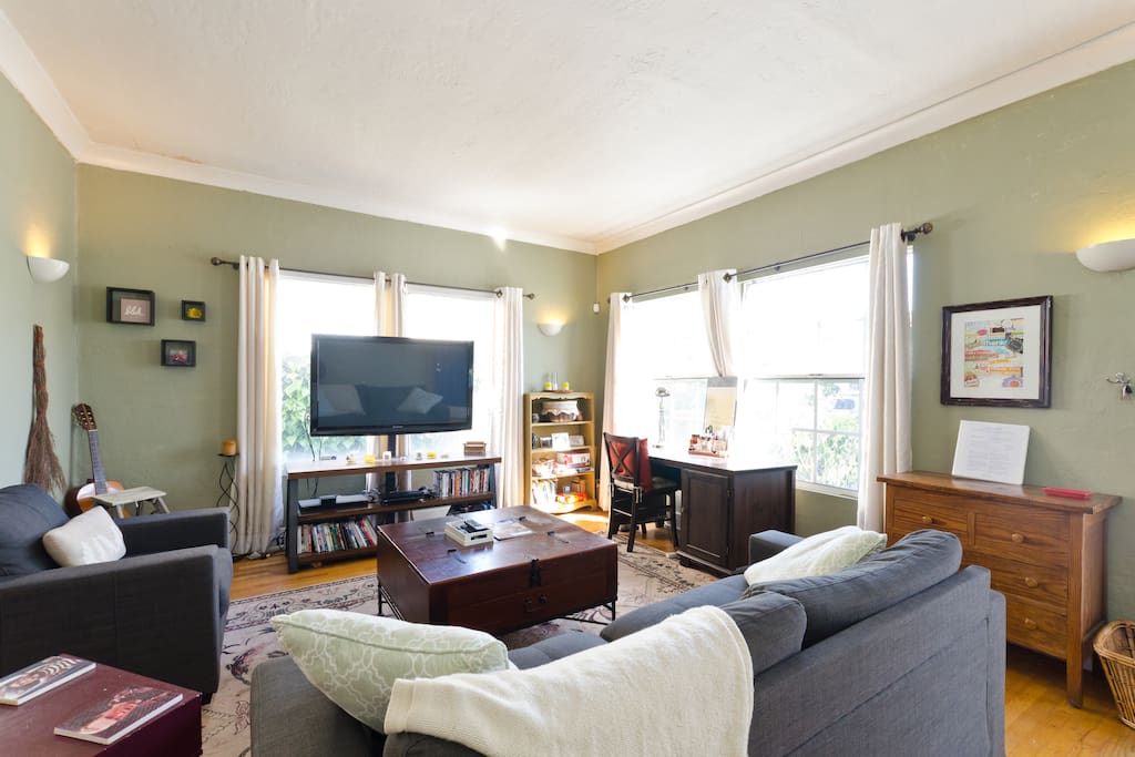 Living room with 52" TV and writing desk.