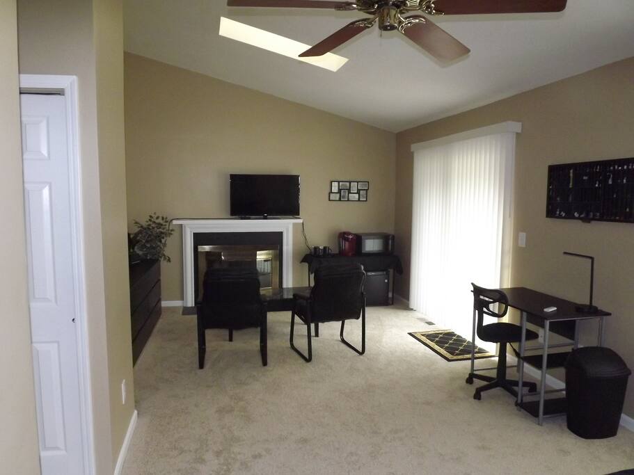 Opposite the bed is a roomy sitting area, which includes a mini-fridge, microwave oven, and Keurig coffee maker. There is also a sliding glass door to a private deck.