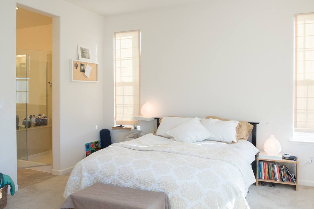 Light spacious bedroom with attached full private bathroom with tub, shower, and two sinks. Nice view for sunrise and set.