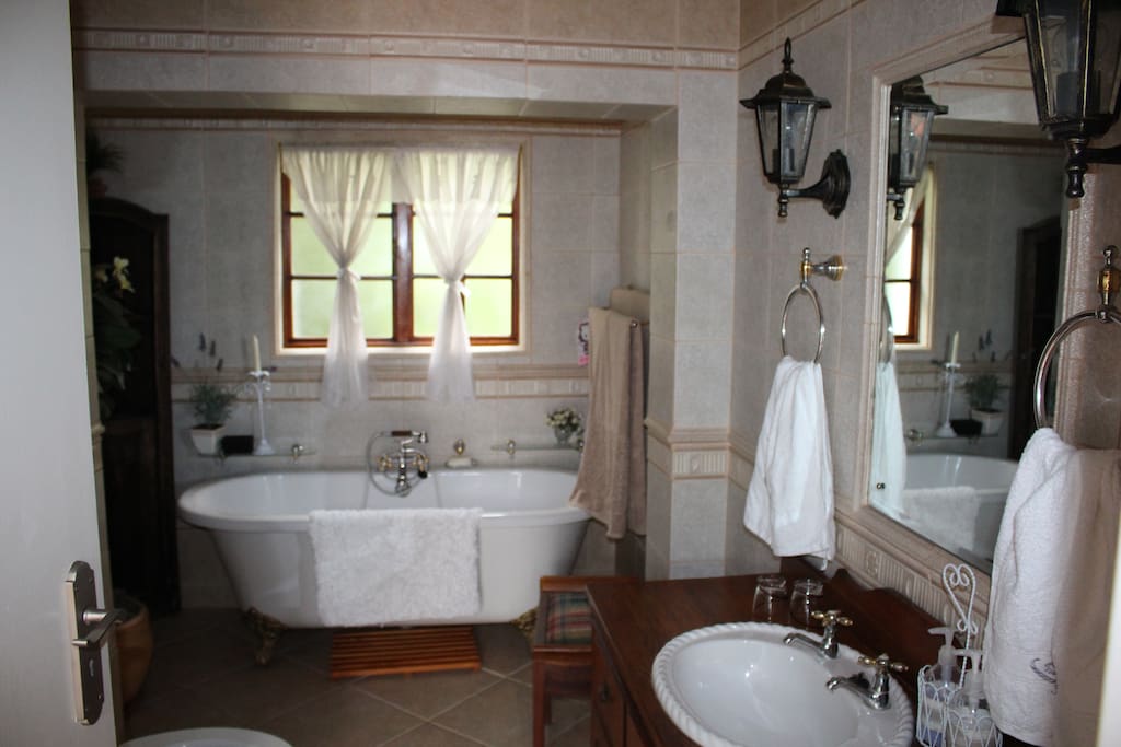 Bath, shower, toilet and basin in antique cupboard close to bedroom