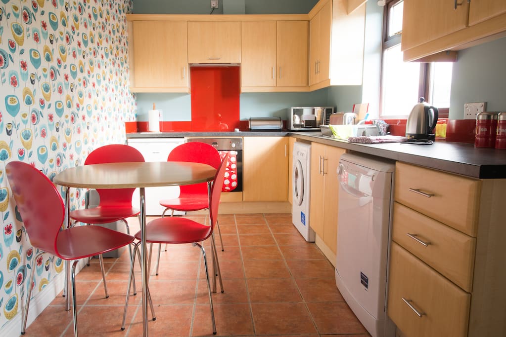Fully fitted well equipped kitchen has crockery and utensils with oven, hob, microwave, dishwasher, washer/drier.
