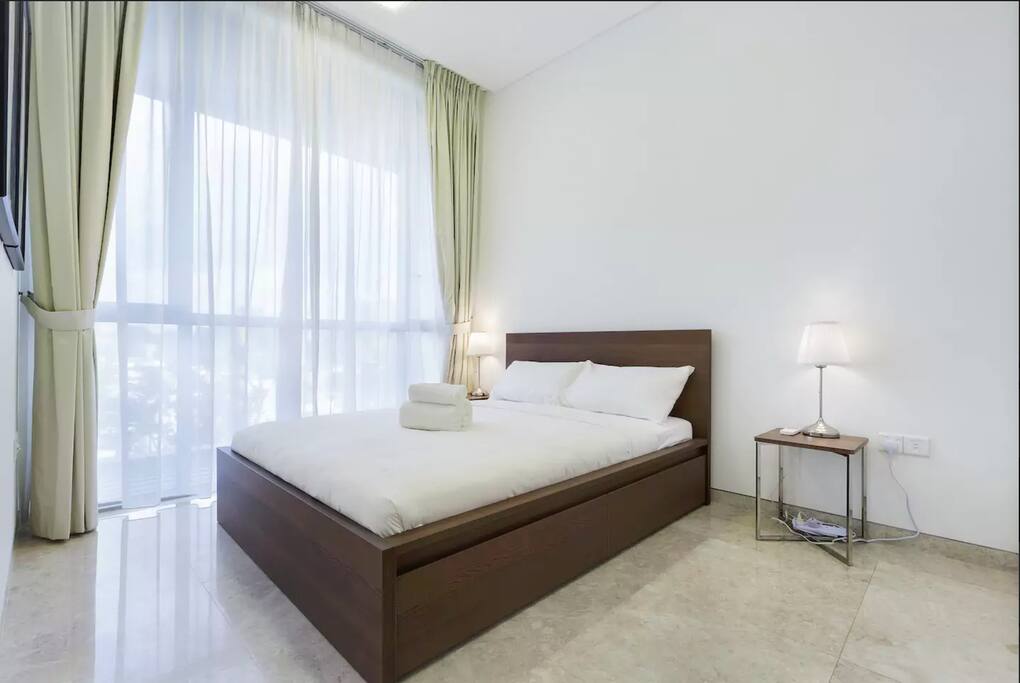 Master bedroom with pool view and queen-size bed.