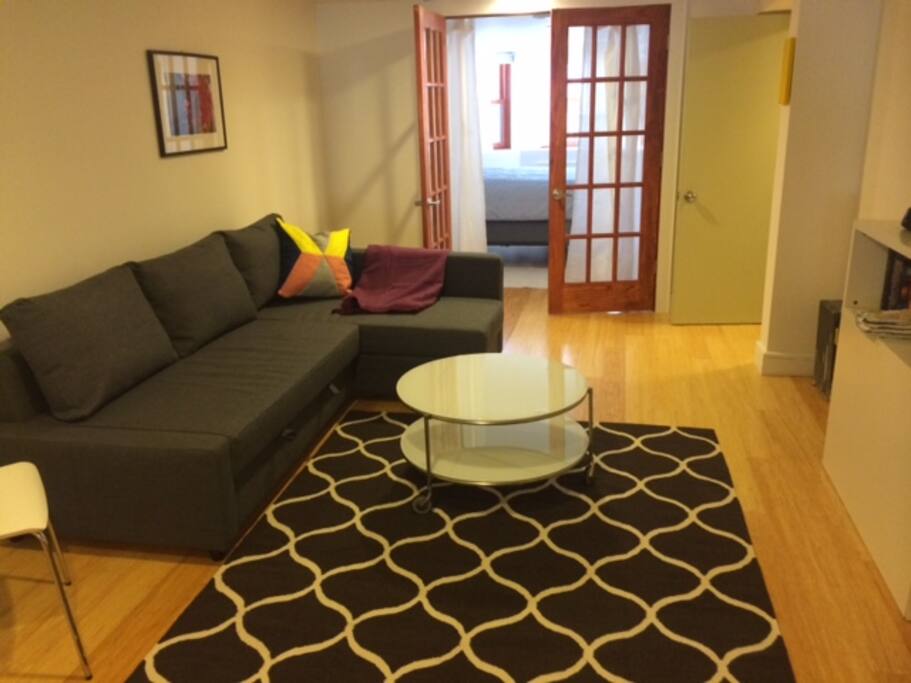 Living room has sofa that opens to a queen size bed.