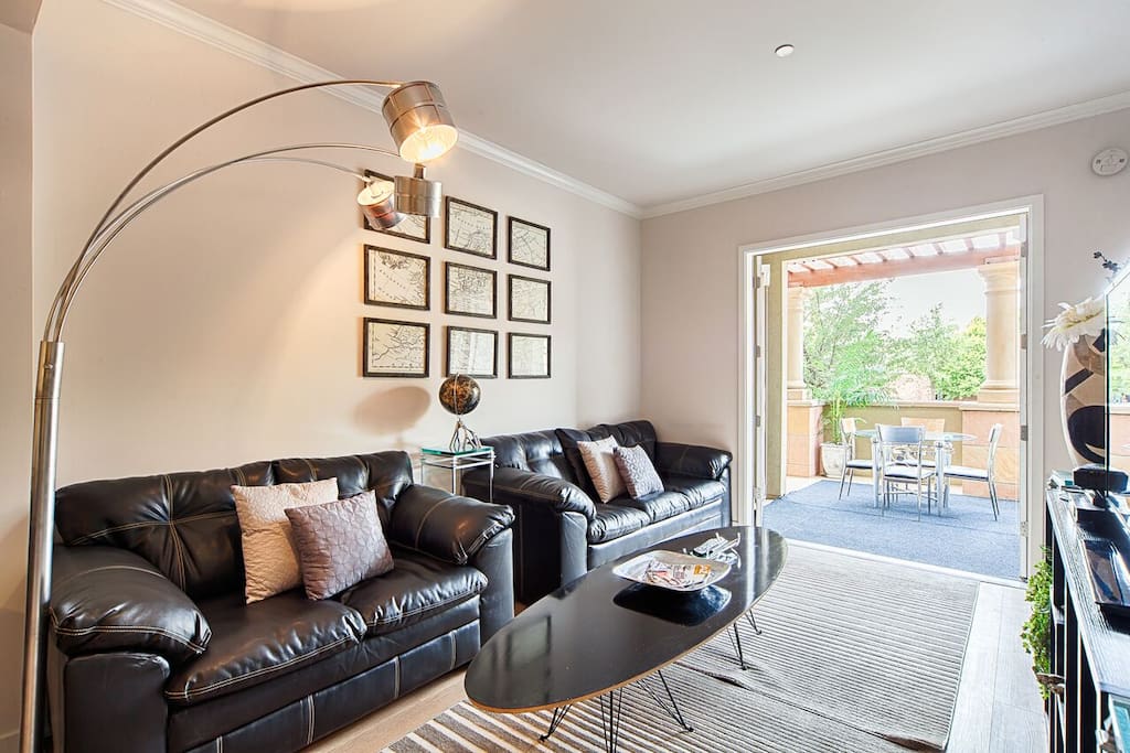 The living room is spacious with comfortable leather sofa's