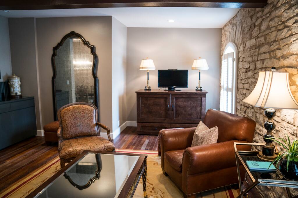 Living room in apartment #2 with queen murphy bed and TV, (and a huge mirror for brides!)