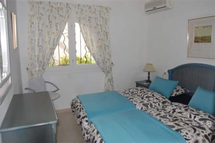 Bedroom with 2 single beds facing the patio