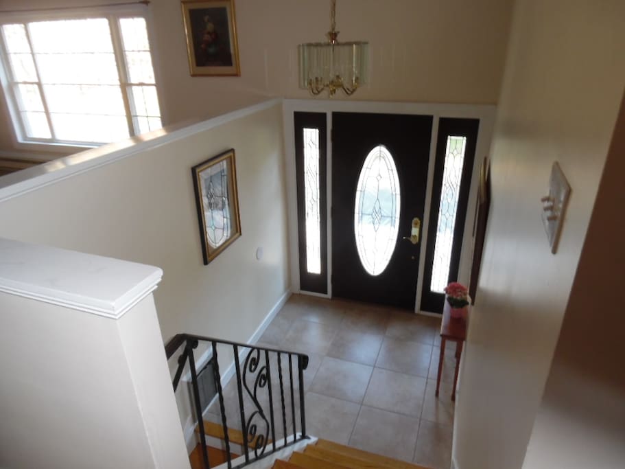 Entry foyer with stairs up to main floor. This is your entrance; bedroom is on the right side of photo.