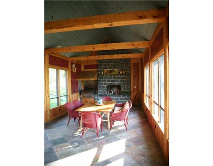 Large screened-in porch with grill and fireplace. Perfect for summer nights.