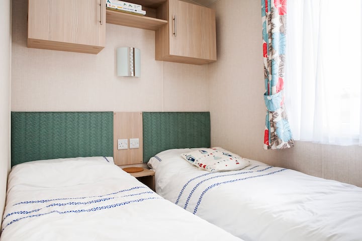 Cómoda habitación doble con libros para niños.