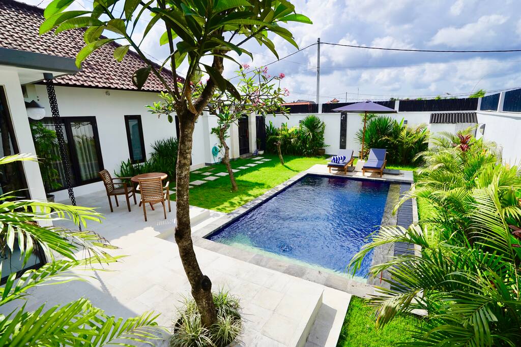 Beautiful bright and breezy private garden with terrace table and chairs, pool, sun umbrella and loungers.