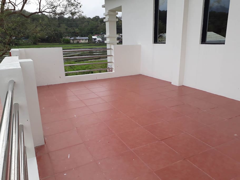 Terrace with a view of the mountains, farmland and the ocean to the back of the property.