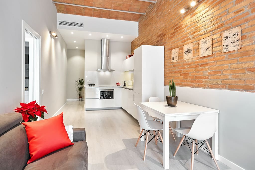 Living area, dining table and kitchen