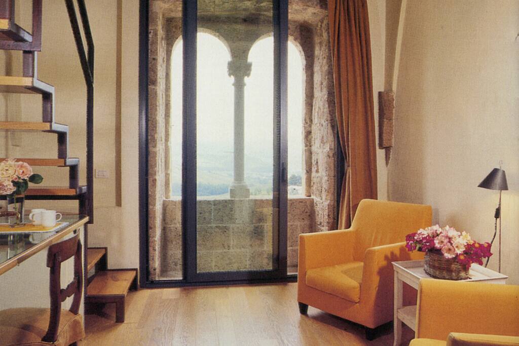 small living room with stairs up to the bedroom