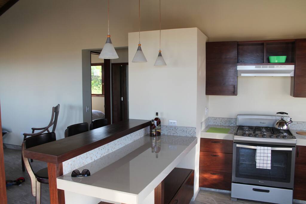 Kitchen and eating bar. Brand new stove, fridge, beds, mattresses