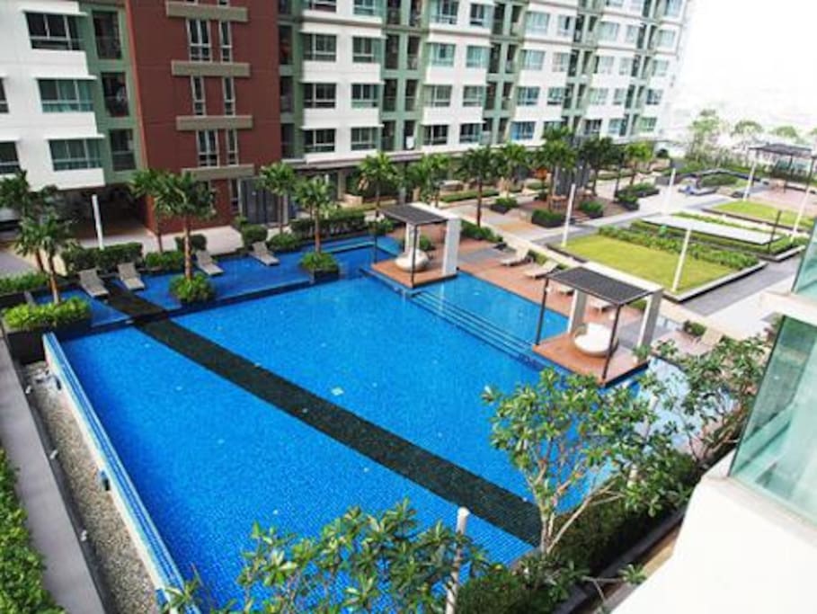Pool visible in the daylight with the city on the right hand side...