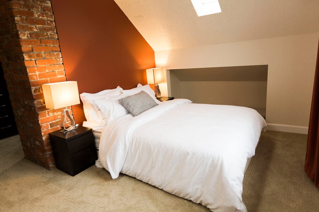 Large bedroom on top floor with dedicated work area and view of downtown and the North Shore mountains. 