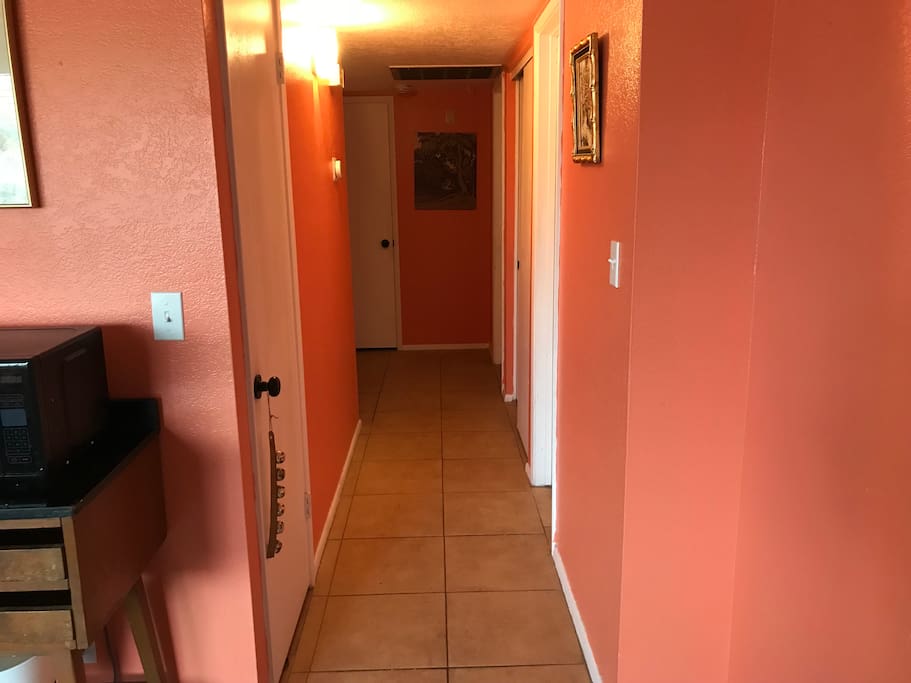 hallway leading to bedrooms and bathroom