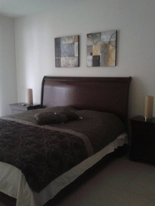 main bedroom with a king size bed, bathroom and walk in closet