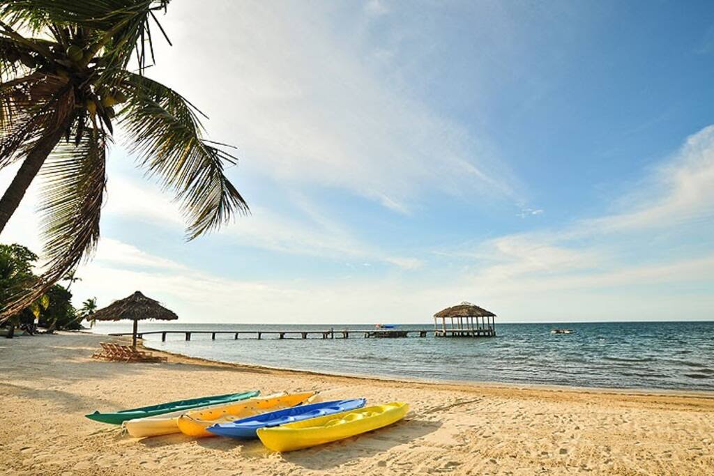 Beach in front of Villa with resort pier in the distance