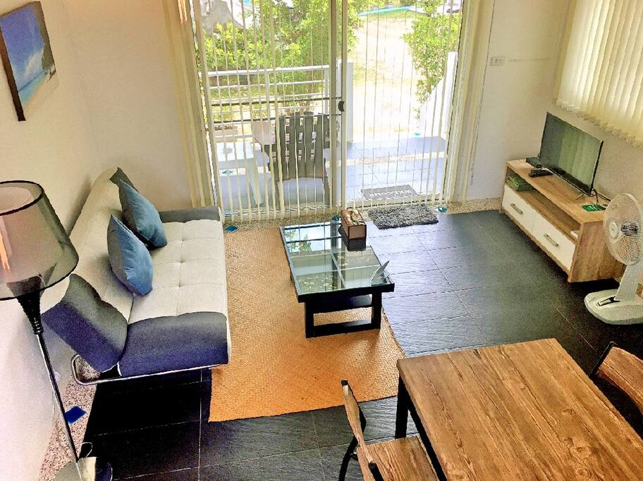 Spacious living room, with a comfy sofa bed, TV and dining table set