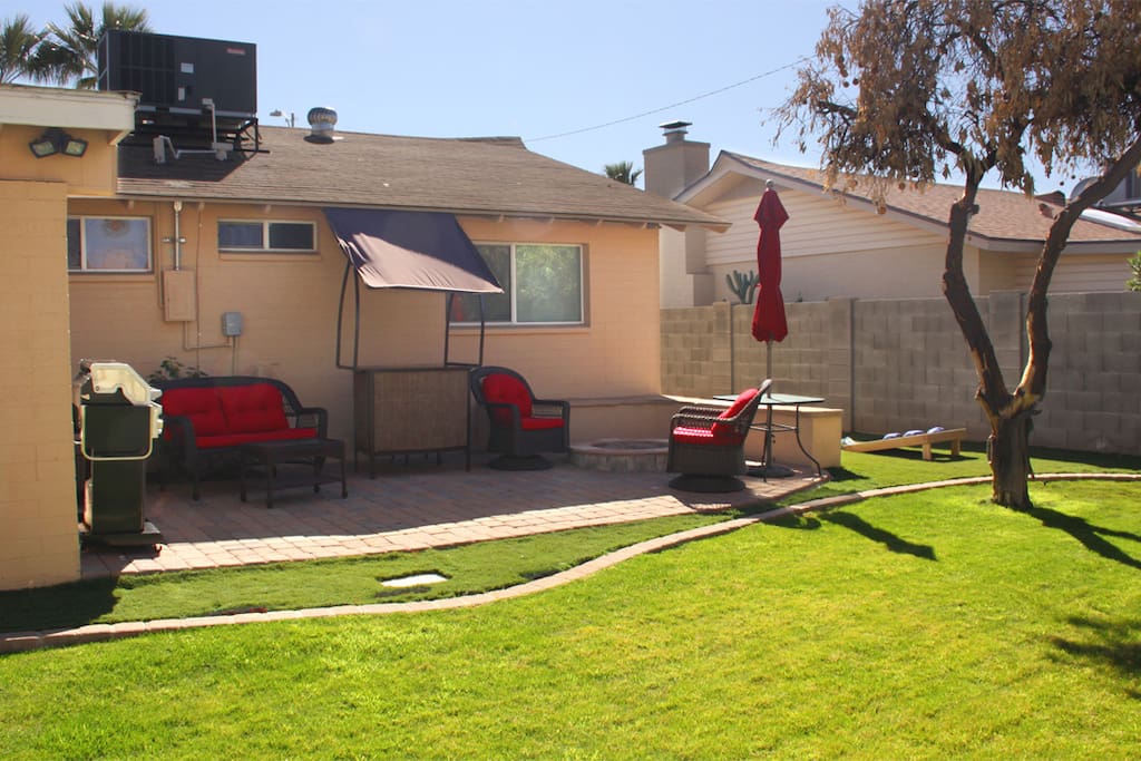 lush grass backyard w citrus trees & patio seating w umbrella for backyard dining + BBQ