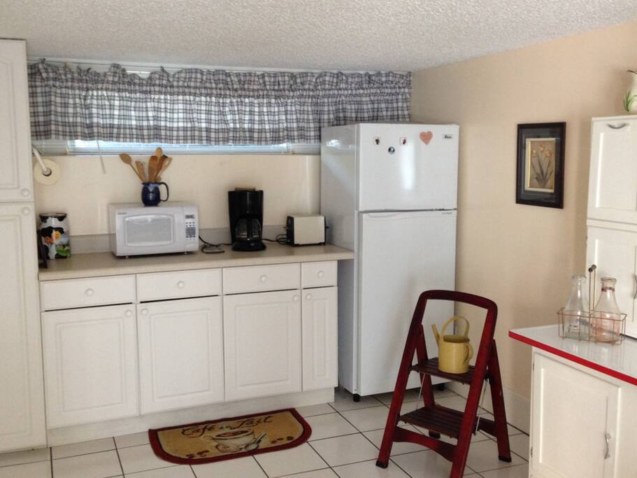 Kitchenette with refrigerator, microwave, coffee maker and toaster